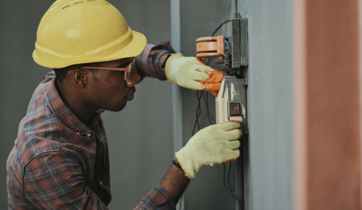 Electrical worker adjusting a panel