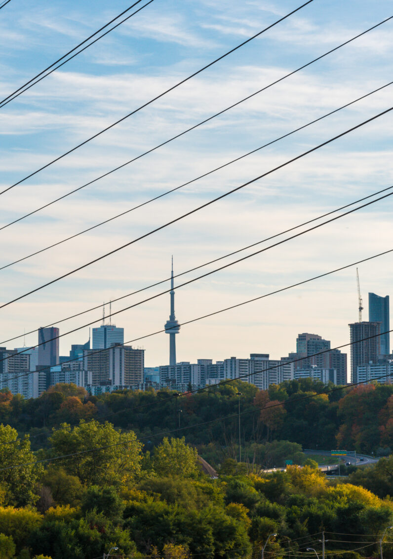 Power lines with a Canadian city in the background