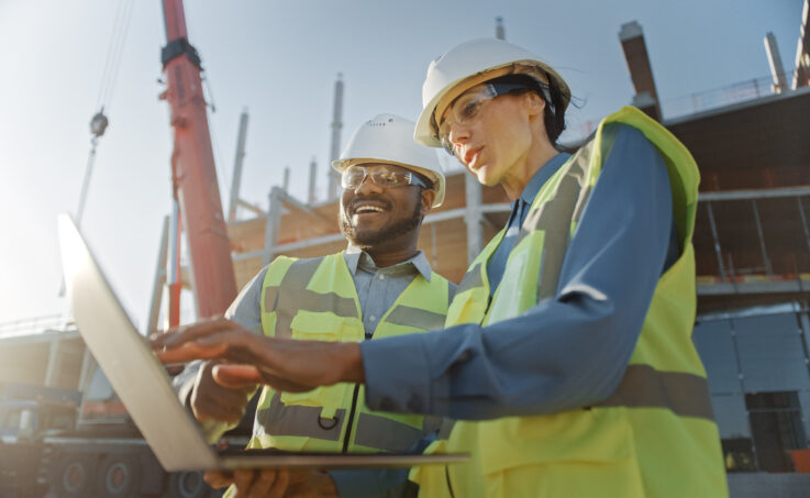 Two specialists inspect new construction