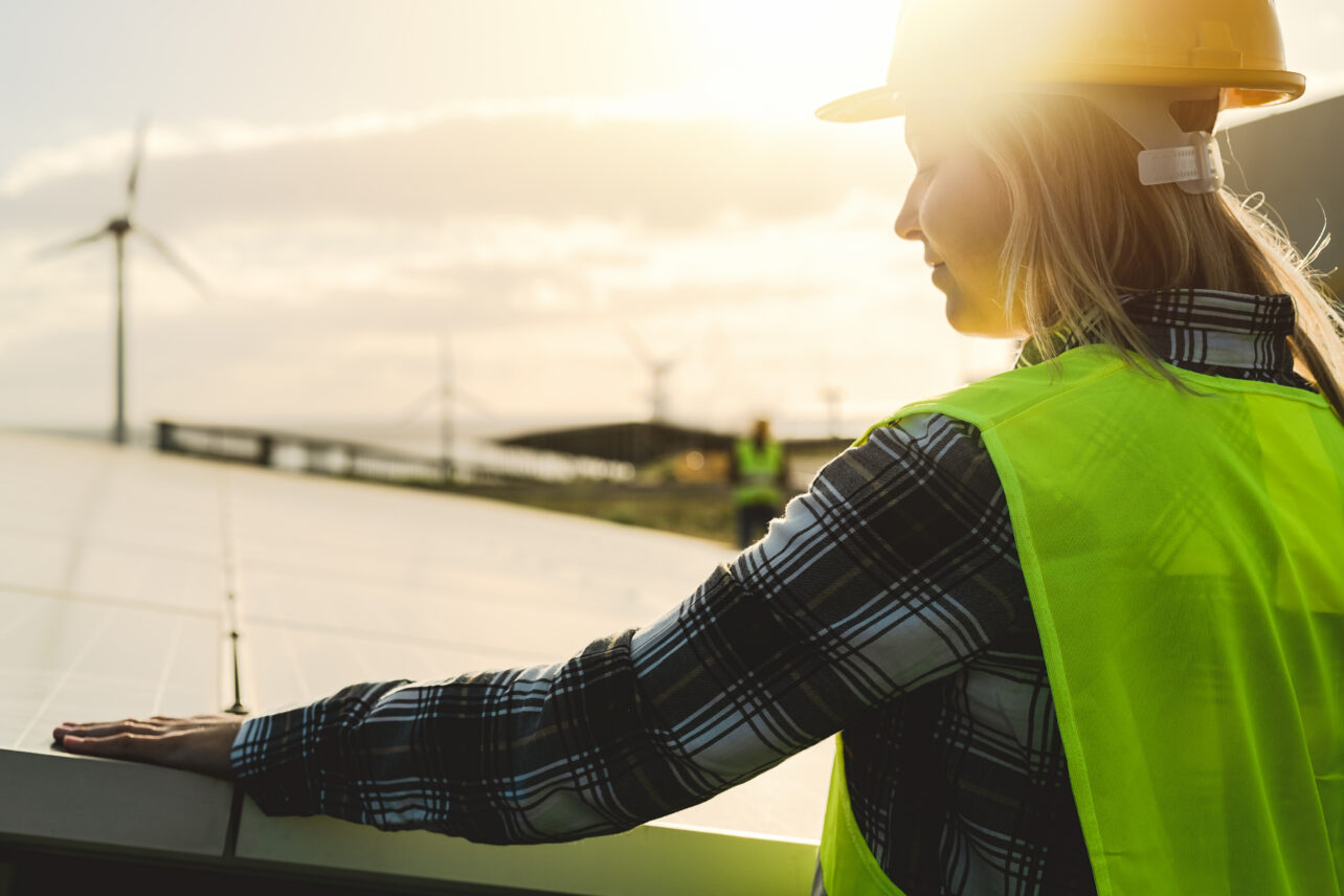 Woman in a hard hard with a solar panel