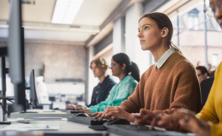 Female Student Studying in Modern School with Diverse Multiethnic Classmates