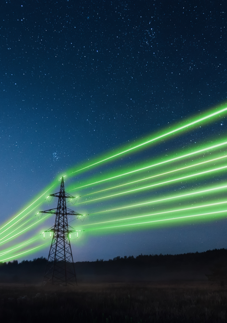 Dark blue night sky with electrical lines between two electrical pylons. The lines are illuminating bright green.