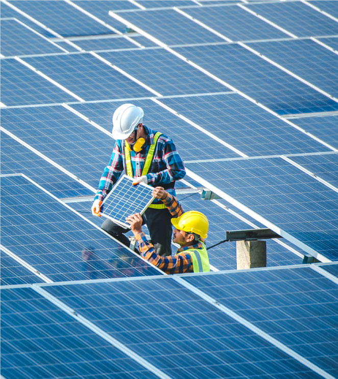 Two people installing solar panels