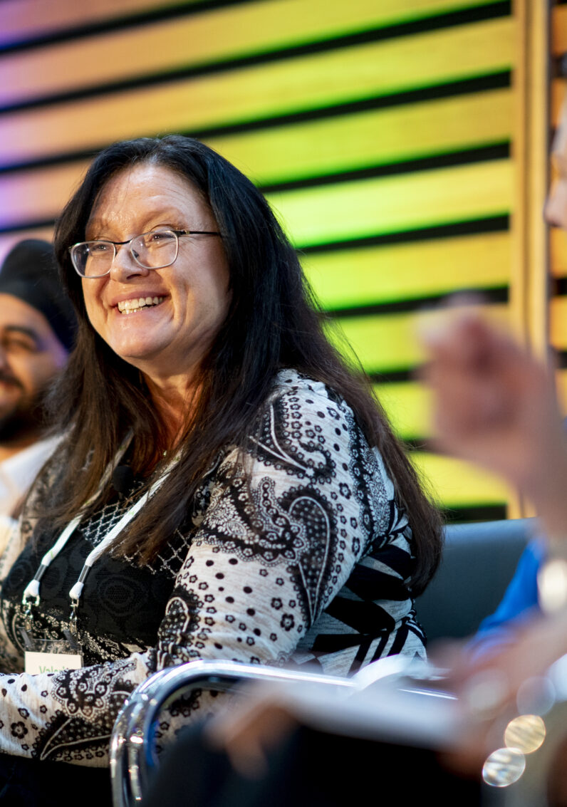Panellist smiles while on stage at the event