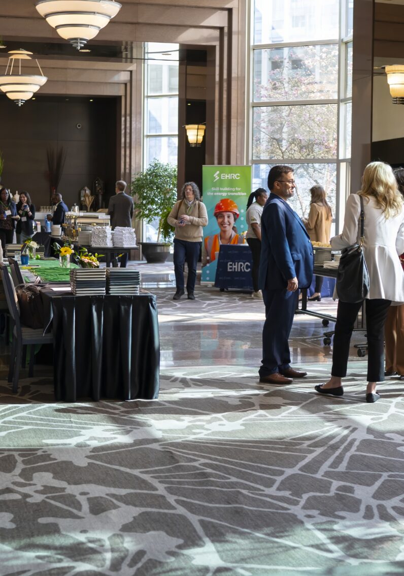 People have a conversation in the hallway of an event