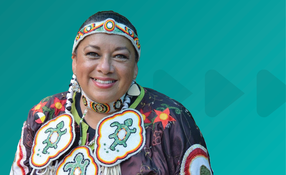 Photo of Kim Wheatley on a teal background