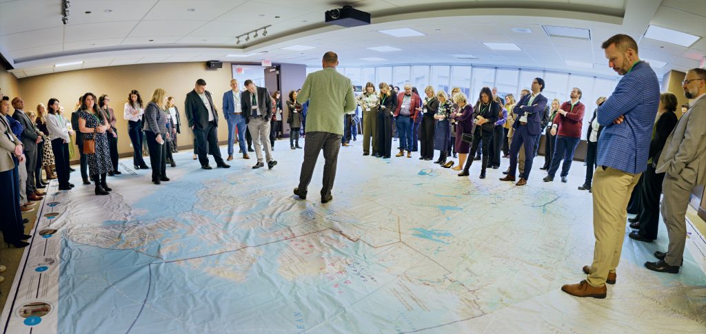 Attendees walk across the Great Canadian Electricity Map