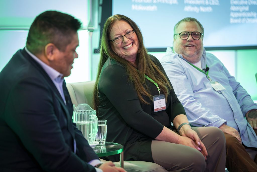 Panellists smile on stage