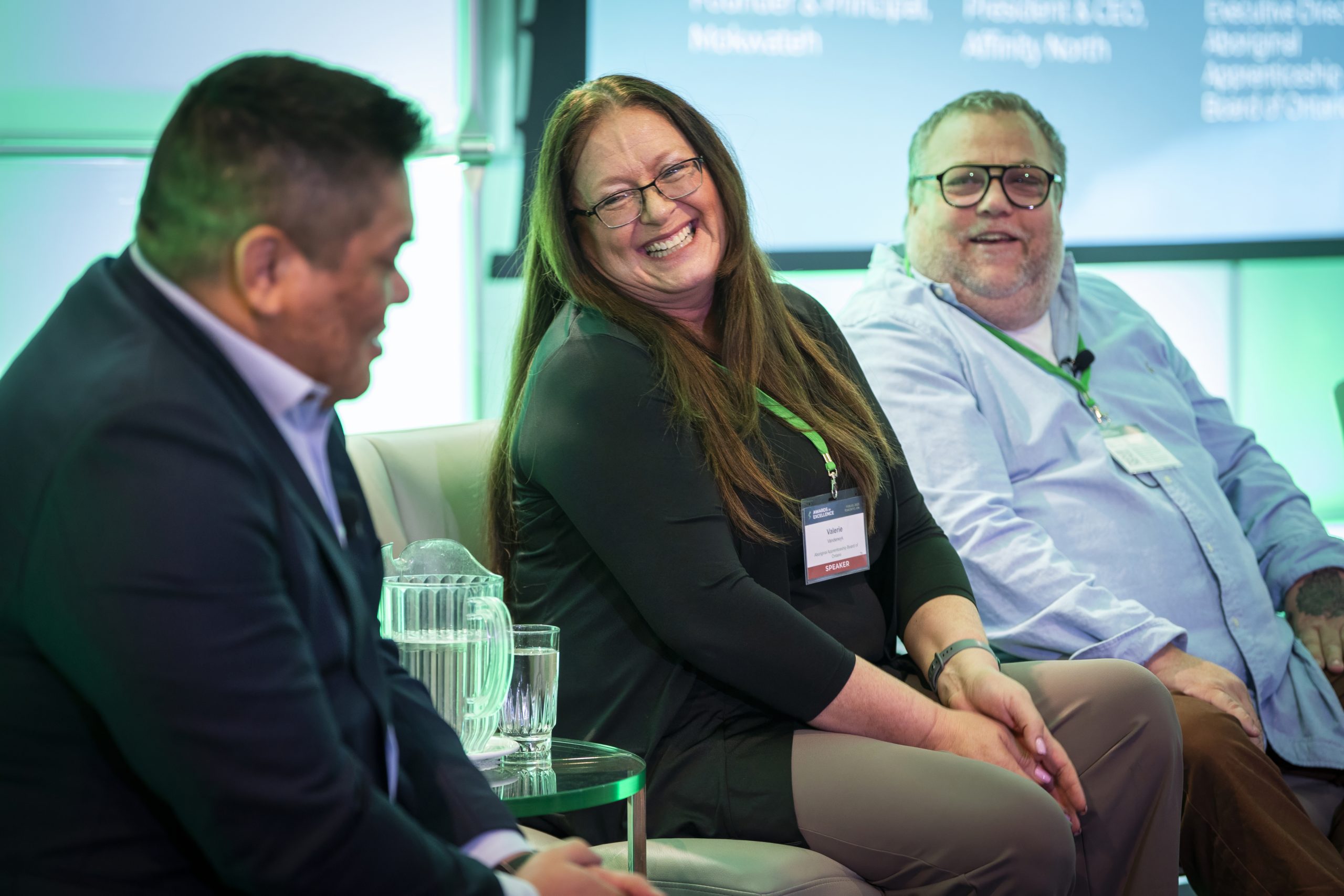 Panellists smile on stage