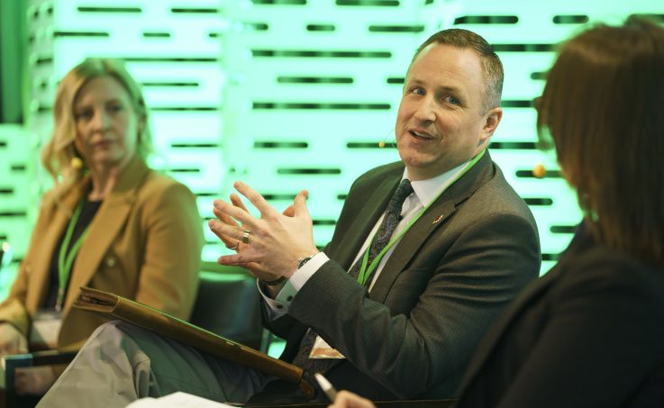 Panellist speaking on a stage